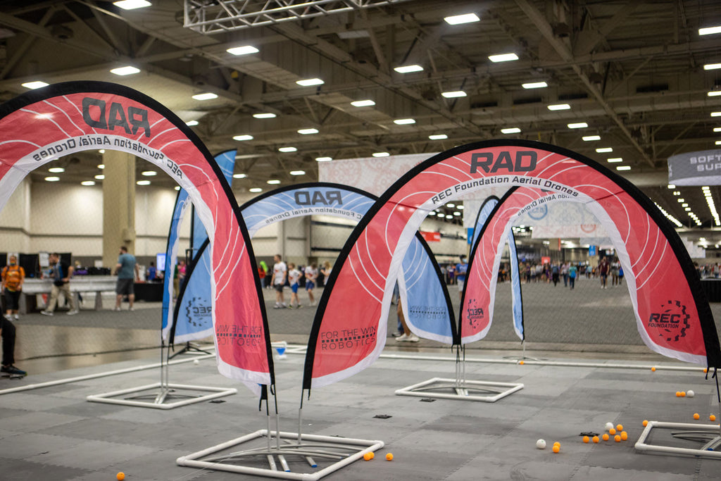 A lower view of the Aerial Drone Competition field arches laid out in an arena