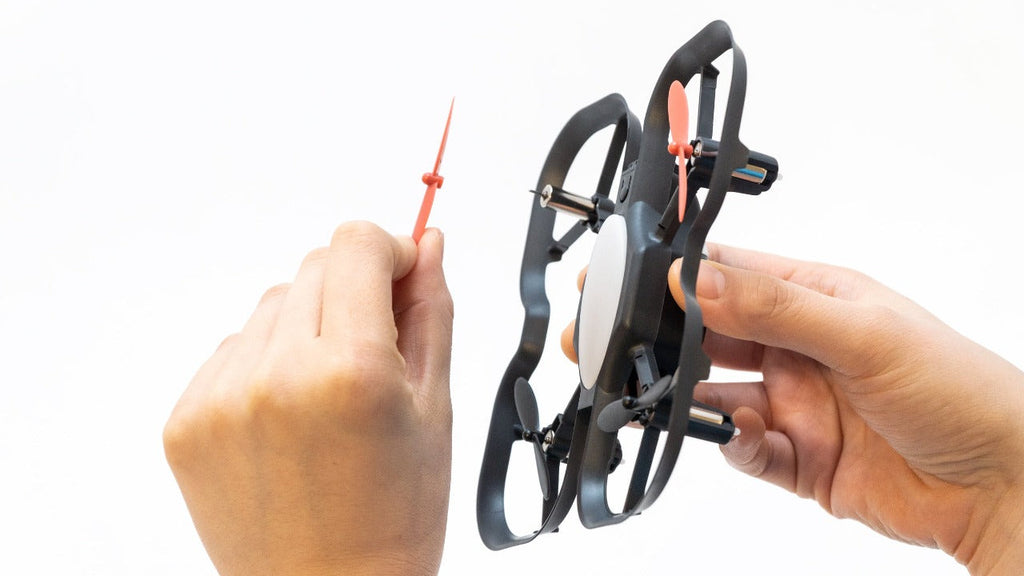 Holding a propeller and a CoDrone EDU, reading to replace propeller