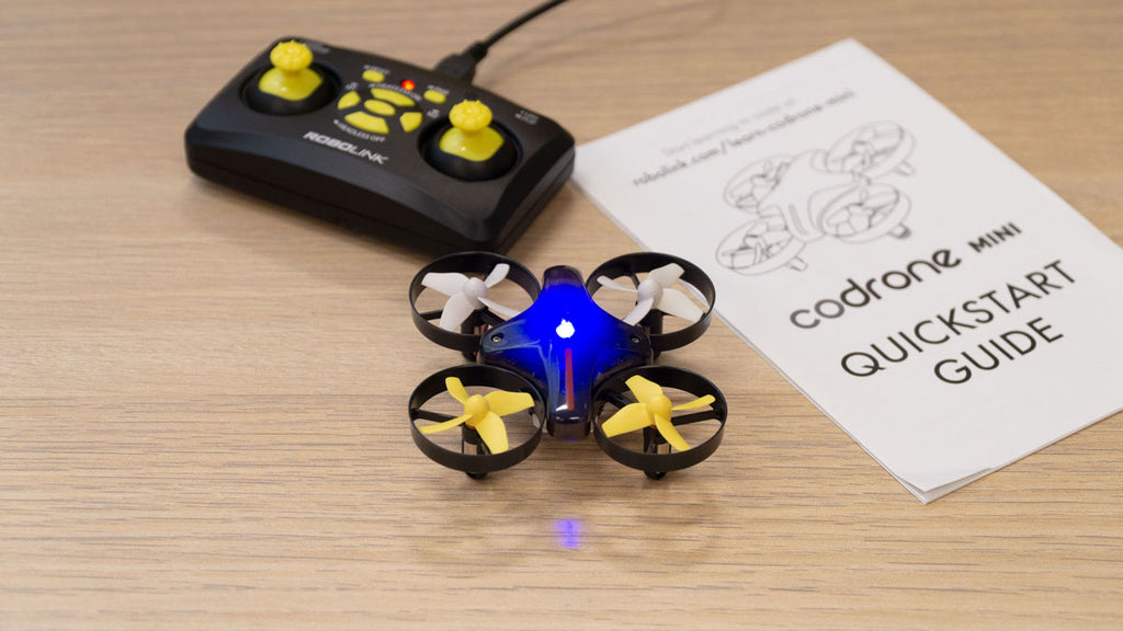 CoDrone Mini and controller on a wooden table